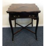 An Edwardian mahogany envelope card table with str