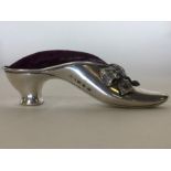 A novelty silver pin cushion in the form of a shoe