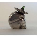 A novelty silver figure of a Mexican in seated pos