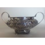 A Georgian embossed silver sugar bowl, the body de