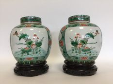 A good pair of Antique Famille Verte vases on stan