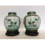 A good pair of Antique Famille Verte vases on stan