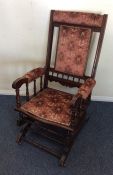 An Edwardian American rocker with upholstered seat