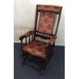 An Edwardian American rocker with upholstered seat