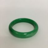 A good green jade slave bangle. Approx. 50 grams.