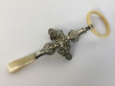 A child's embossed rattle decorated with balls. Ap