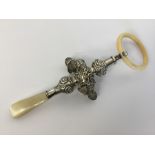A child's embossed rattle decorated with balls. Ap