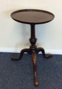 A Georgian mahogany side table on three spreading