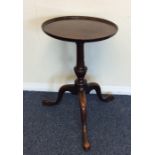 A Georgian mahogany side table on three spreading