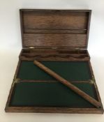 An oak carved travelling stationery box with fitte