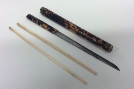 An unusual Asian chopstick and knife set in tortoi