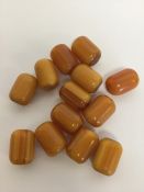 A collection of amber cylinder shaped beads. Est.
