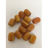 A collection of amber cylinder shaped beads. Est.