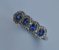 An attractive 18 carat sapphire four cluster ring.