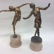 A pair of stylish figures of dancing ladies on ony