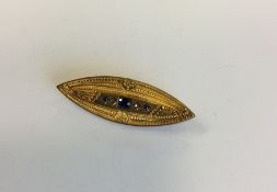 A sapphire and diamond boat shaped brooch with loc