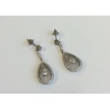 A pair of French pear shaped diamond drop earrings