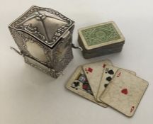 A novelty silver playing card holder in the form o