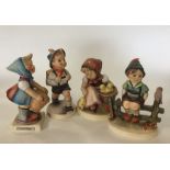 A group of four Hummel figures of children. Est. £