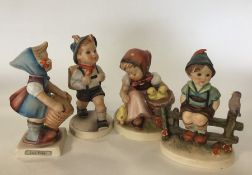 A group of four Hummel figures of children. Est. £