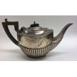 A bachelor's half fluted silver teapot with hinged