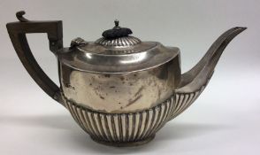 A bachelor's half fluted silver teapot with hinged