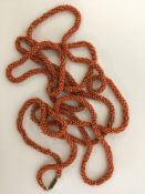 A good long string of Antique amber beads with gol