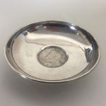 A small silver pin dish inset with coin. Approx. 5