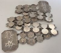 CHINESE: A large silver two strand belt with large