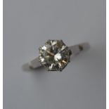 A diamond ring, the round brilliant cut weighing a