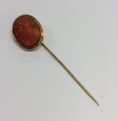 An Antique gold coral stick pin with twisted pin.