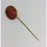 An Antique gold coral stick pin with twisted pin.