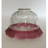 A cranberry glass mounted lampshade with swag deco