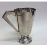 A heavy Art Deco silver tapering mug on circular b