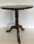 An Antique fruit wood tripod table with hinged top