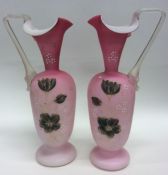 A pair of good cranberry ewers decorated with flow