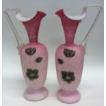 A pair of good cranberry ewers decorated with flow