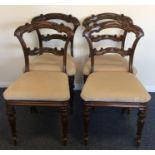 A set of four mahogany dining chairs decorated wit