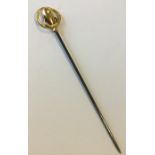 CHARLES HORNER: A small gold mounted stick pin. Ap