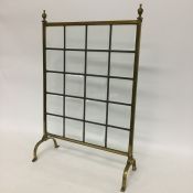 A lead glazed brass fire screen together with one