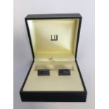 A boxed pair of Dunhill cufflinks decorated with e