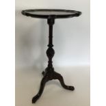 A mahogany tripod table with turned stem. Est. £25