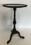 A mahogany tripod table with turned stem. Est. £25