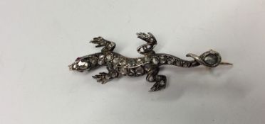 An unusual gold and silver brooch in the form of a