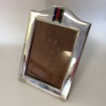 A rectangular silver picture frame with enamelled
