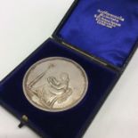 A cased silver medallion. Est. £20 - £30.
