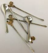 An unusual set of four silver gilt cocktail sticks