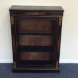 An ebony and walnut brass mounted pier cabinet wit