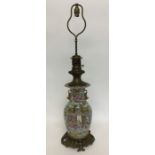 An ormolu Canton vase mounted as a lamp with brass