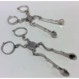 Two pairs of Georgian silver scissor action sugar